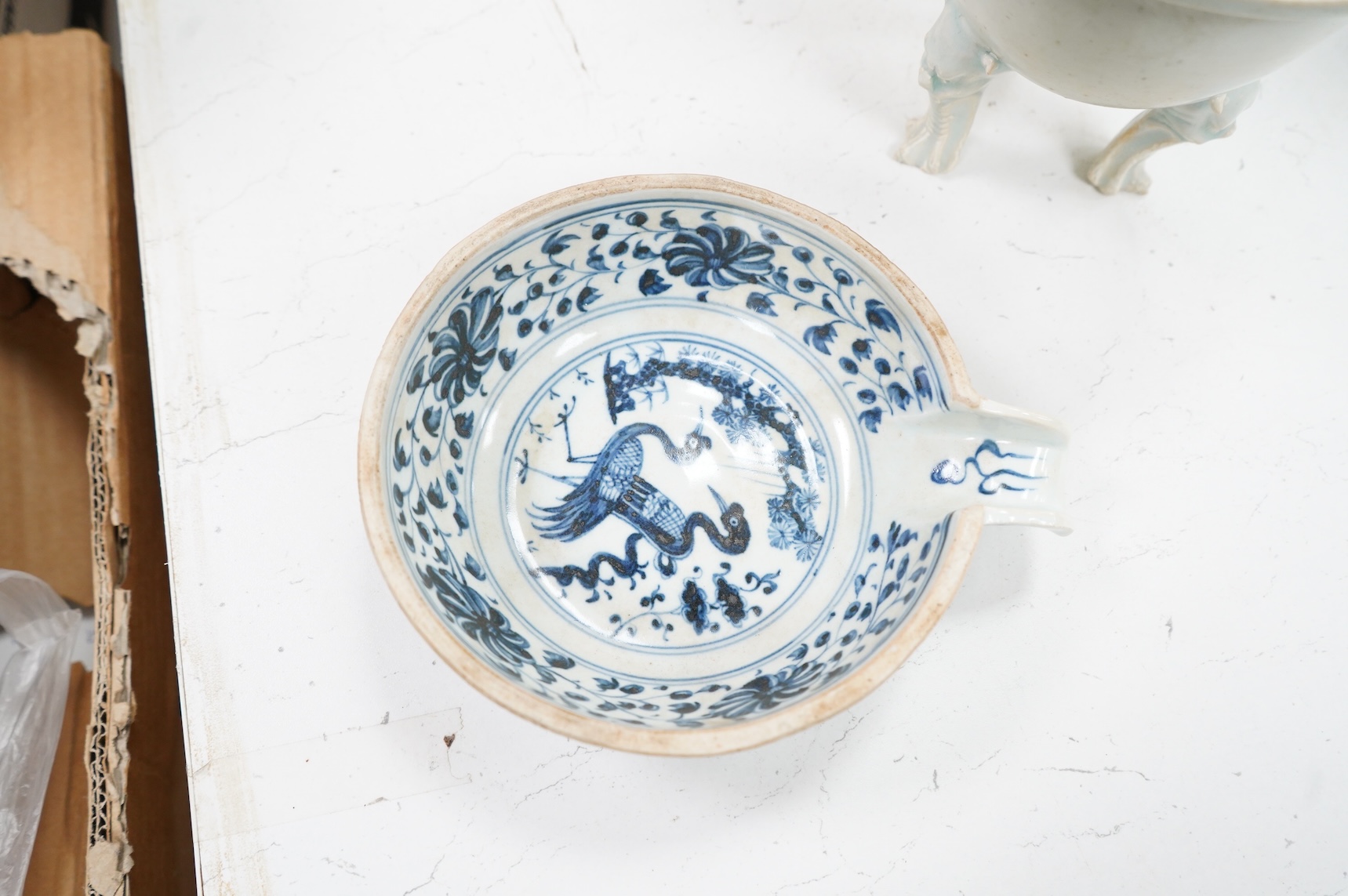 A Chinese three footed censer and a blue and white pouring bowl, largest 15cm high